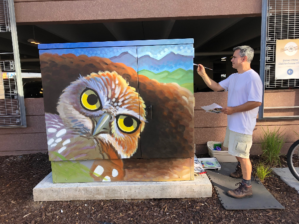 Larry Tucci painting a transformer cabinet