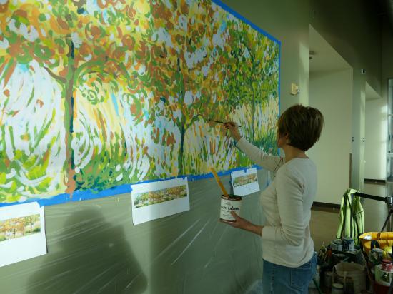 Artist Lisa Cameron Russell painting the mural