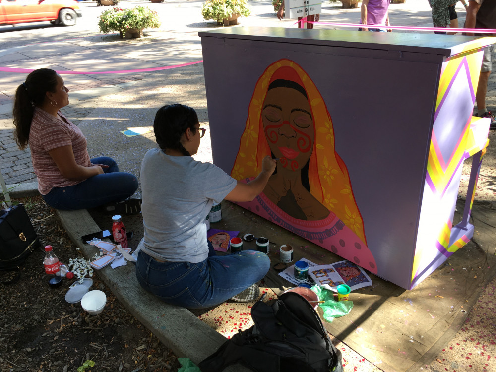 Zulay painting the back of the piano