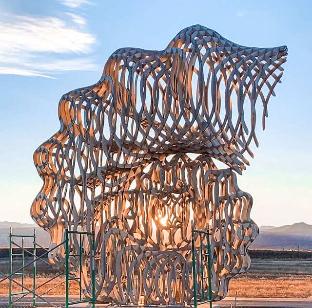 The sculpture lit by the sunset.