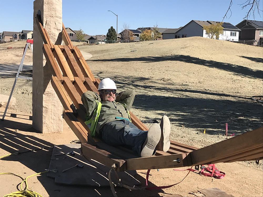 Artist Joe McGrane testing the hammock after install.
