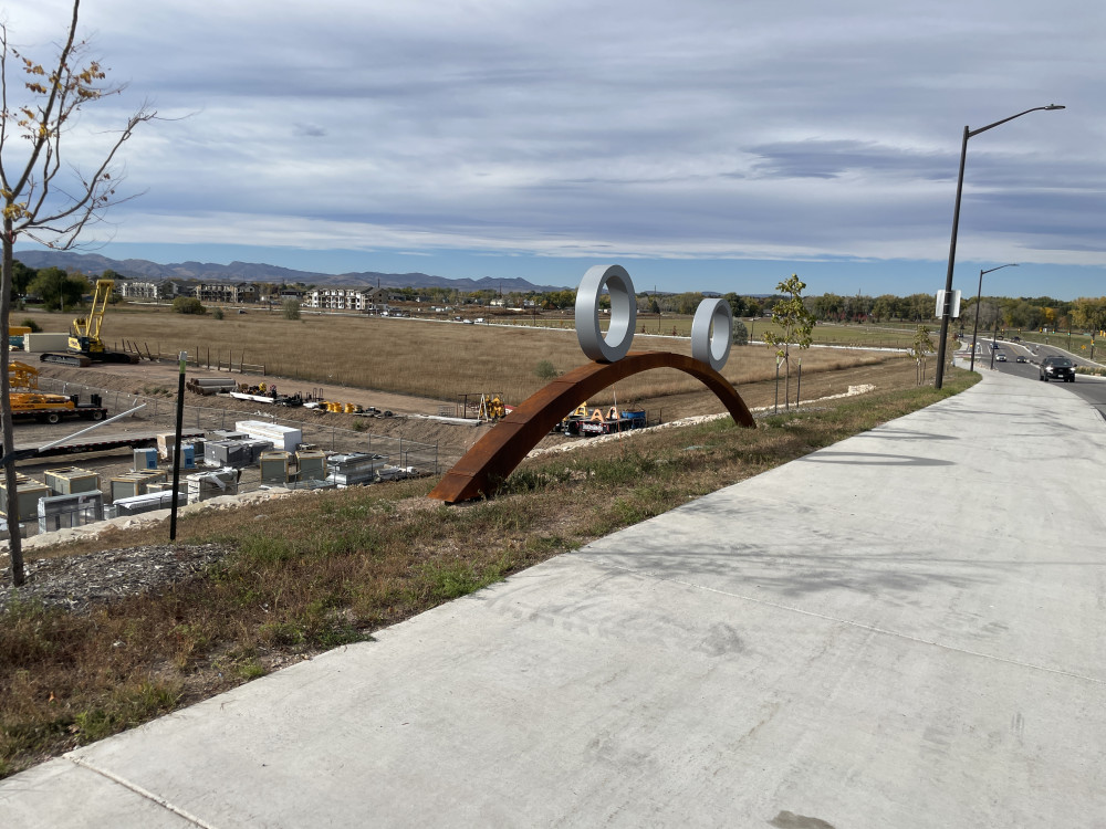 Swirl sculpture with rings on the west side of the street.