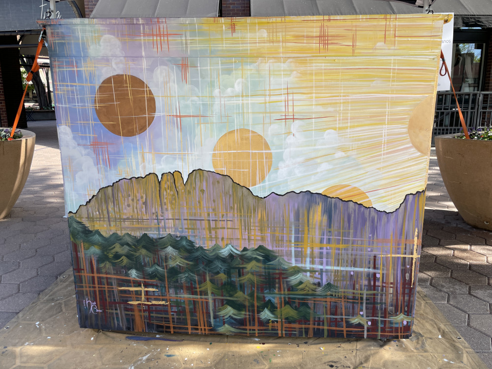 back of a piano mural with mountain and multiple circles over