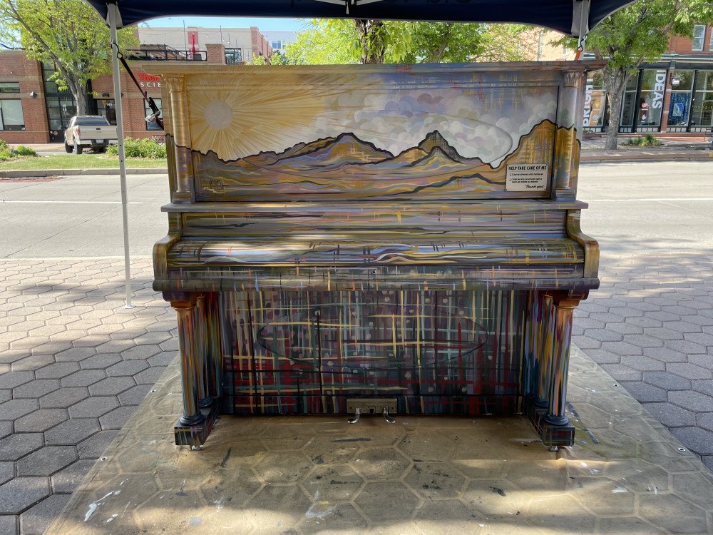 piano painted with mural of mountains