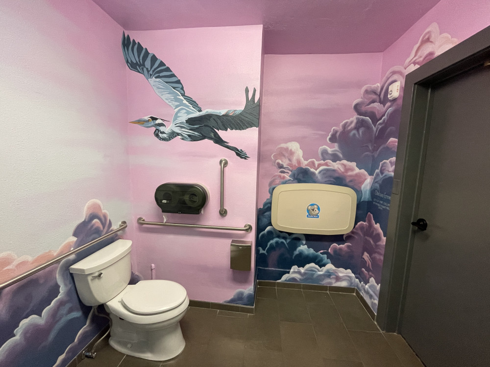 mural of pink and purple clouds with a large bird