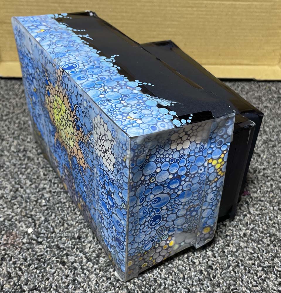 paper model of a transformer cabinet with mural design