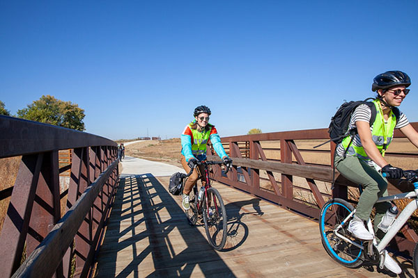 Cyclists ride together on a trail.