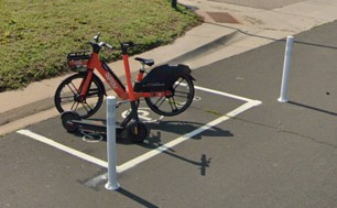 A bike and scooter parking area on a street