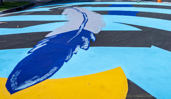 Feather painted on street.