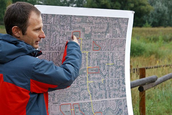 Man pointing to a map of a city