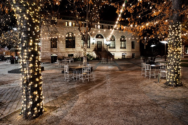 City square at night lit up with holiday lights