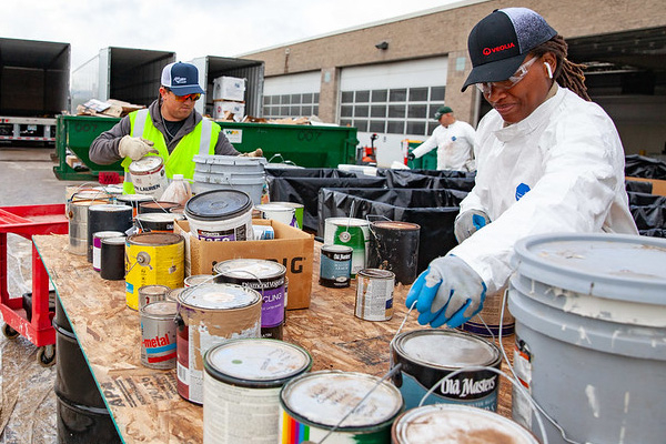 Staff sort old paint dropped off at the Household Hazardous Waste event.