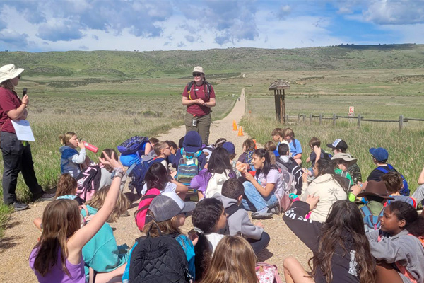 A Natural Areas educator leading a school program with kids