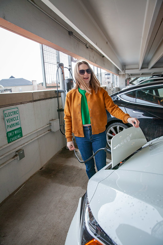 A person charging an electric vehicle