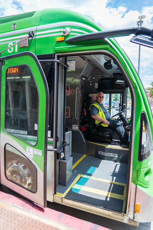 A bus driver in a green bus