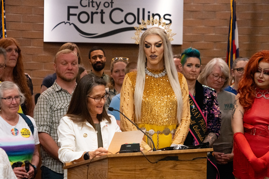 Drag artist Krisa Gonna accepts the June 2024 Pride Month proclamation from Mayor Arndt after performing in City Hall.