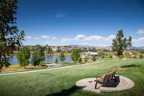 Photo showing a neighborhood, bike path, park, park bench and pond