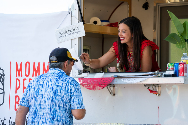 Person selling food out of a food truck