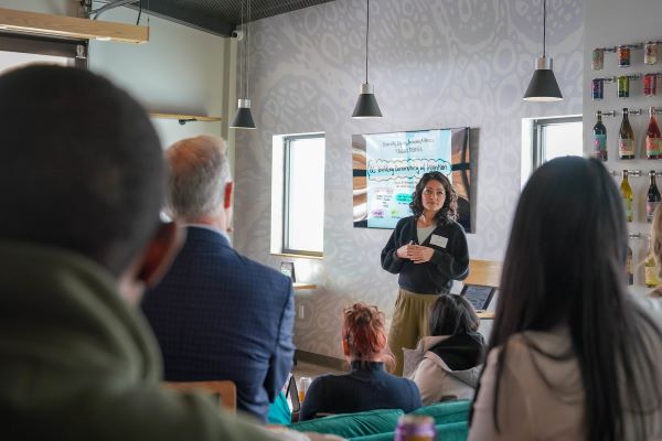 Group of people sitting and watching a presenter speaking