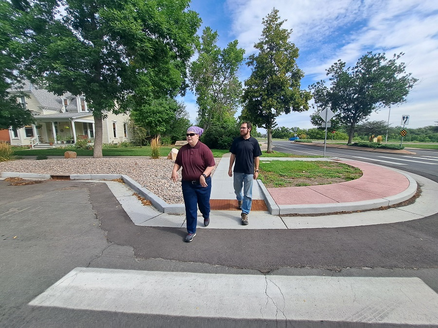 pedestrians preparing to cross the street in a curb extensions at Oak St./Whedbee St.