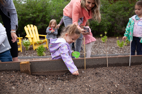 mom with child at garden bed
