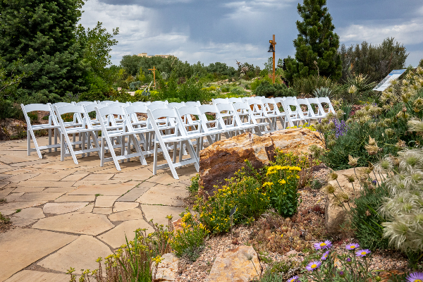 chairs in rock garden with flowers