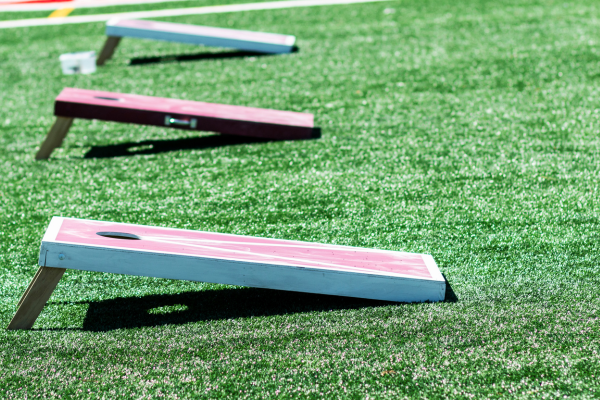 three cornhole boards in a row