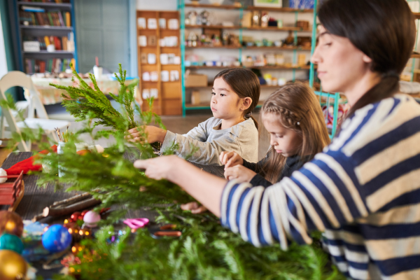 kids and adult making holiday wreaths