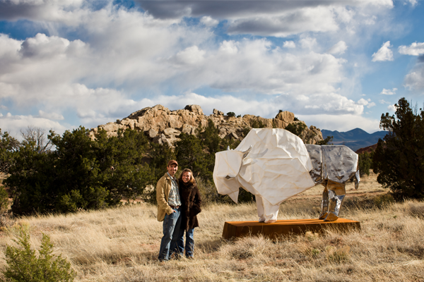 Jennifer & Kevin Box standing by White Bison sculpture