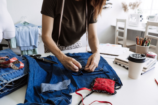 woman mending denim by hand