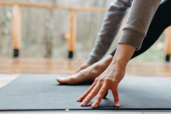 person stretching on a yoga mat