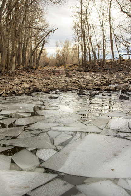Dry river bed next to a pool on North Fork of the Poudre River at Cherokee Park Road