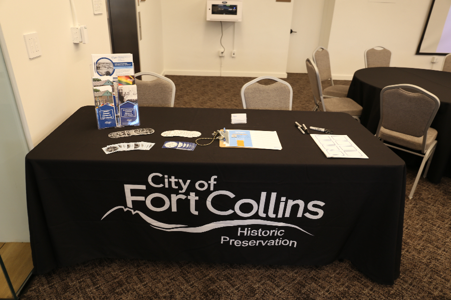 Black cloth covered table with brochures and stickers