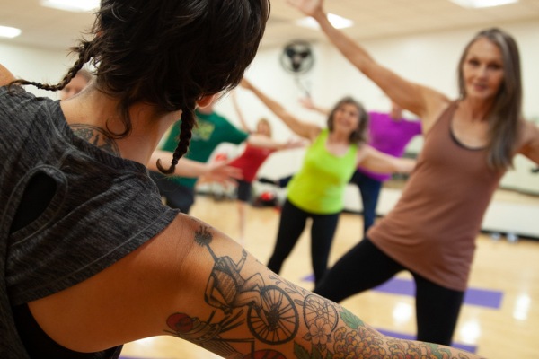 employees doing yoga in a gym