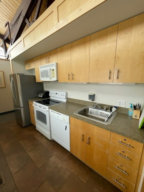 Primrose Studio kitchen with a sink, dishwasher, stove, microwave, toaster, and refrigerator