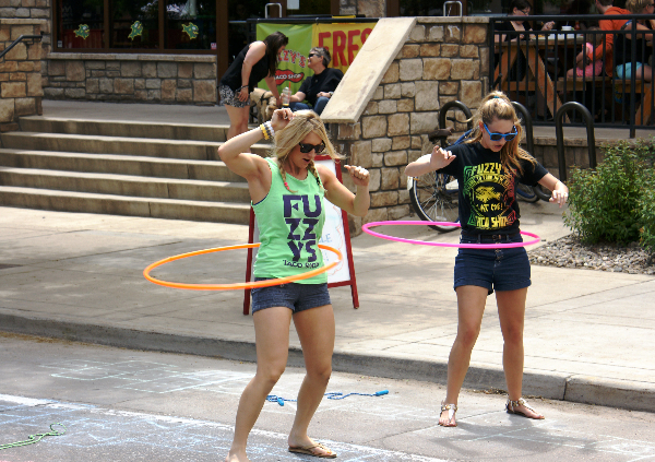 Folks hula hoop at a previous Open Streets event