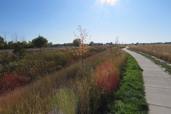 image of grasslands and paved trail