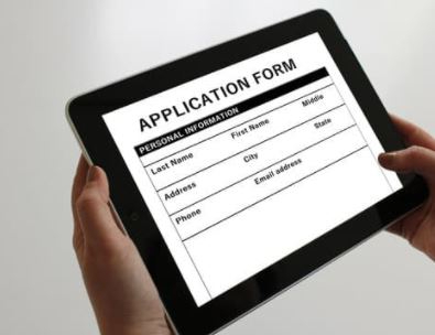 hands holding job application on a digital tablet
