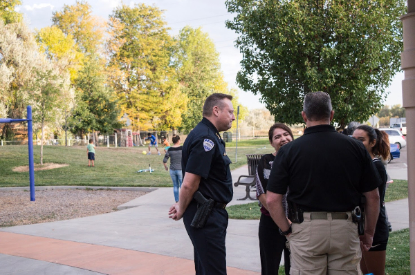 police talking with residents at a community picnic
