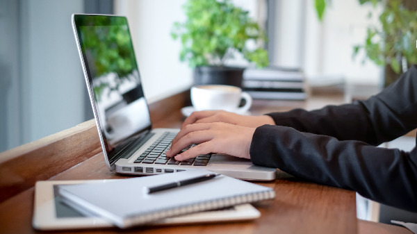 hands typing on a laptop
