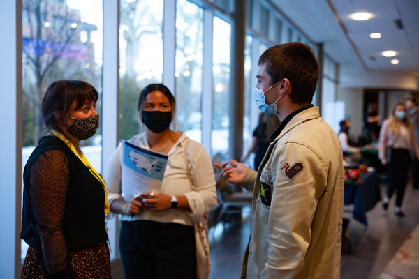 People in masks speaking to each other