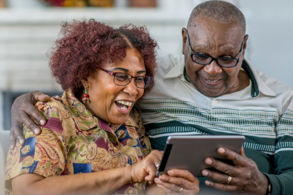 Older couple using computer tablet