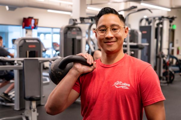 PJ Weitzel holding a kettlebell in a weight room