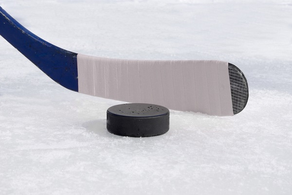 hockey stick and puck on ice