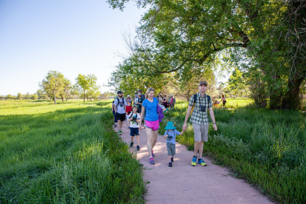 Families walking on paved trail.
