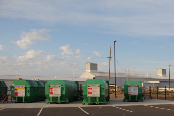 Large green recycling bins