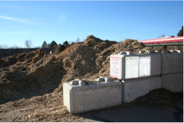 Pile of mulch bordered by concrete blocks.