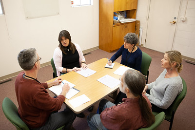A group of people having a discussion at a table