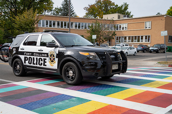 A photo of a Fort Collins Police Services vehicle at a crosswalk.