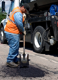 Worker filling pothole
